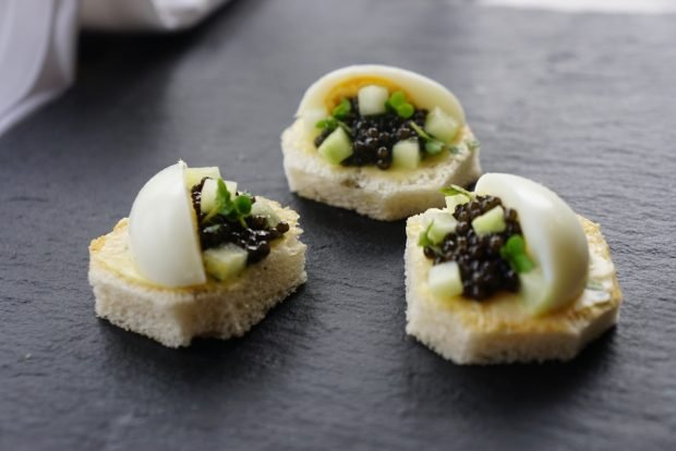 Canapes with quail eggs and caviar are a simple and delicious recipe for how to cook step by step