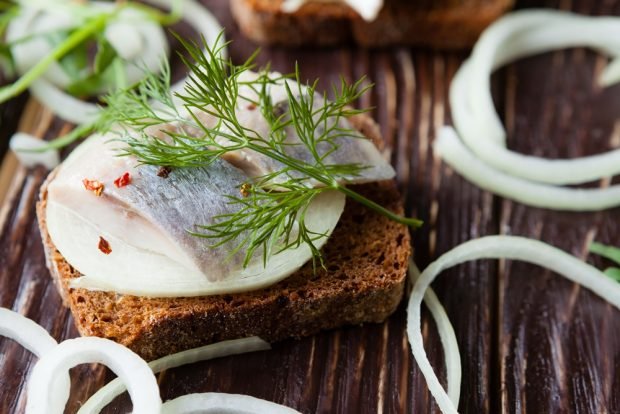 Sandwiches with herring and black bread for the festive table