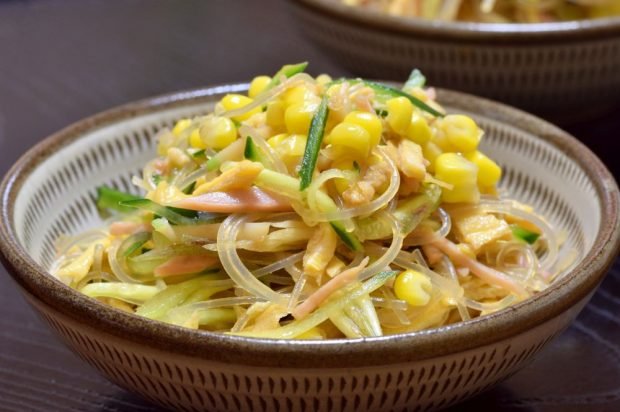 Salad of funchosa, ham, corn and cucumbers