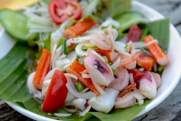 Sea salad with cucumbers and tomatoes