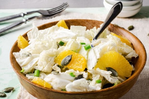 Peking cabbage salad with orange and pumpkin seeds