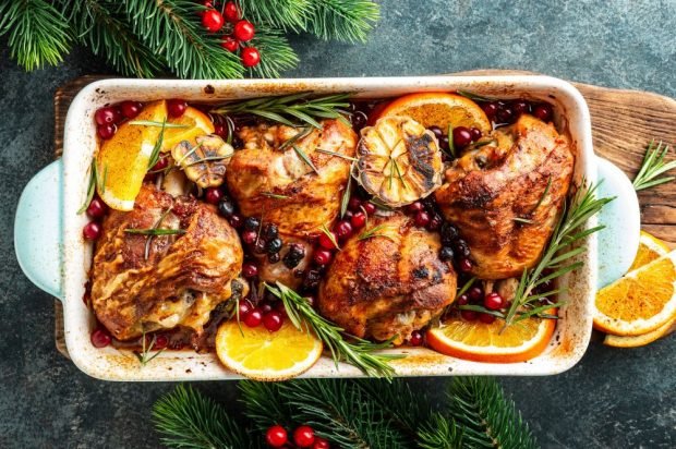 Turkey thighs baked with garlic, oranges and cranberries 